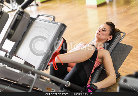 To use this stock image in your creative project, please select the size you need over to the right and click the "Add to Cart" button.
Your downloaded image will come with the Cutcaster watermark removed so don’t worry about the watermark you see on this page. Fit young woman doing leg presses in the gym stock photo, Side view of a fit young woman doing leg presses in the gym by Satura86