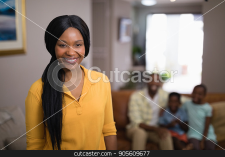 To use this stock image in your creative project, please select the size you need over to the right and click the "Add to Cart" button.
Your downloaded image will come with the Cutcaster watermark removed so don’t worry about the watermark you see on this page. Portrait of smiling woman with family in background stock photo, Portrait of smiling woman with family in background at home by Wavebreak Media