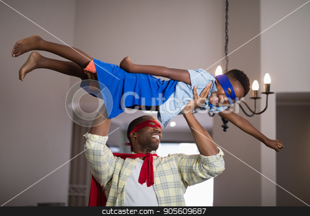 To use this stock image in your creative project, please select the size you need over to the right and click the "Add to Cart" button.
Your downloaded image will come with the Cutcaster watermark removed so don’t worry about the watermark you see on this page. Playful father and son in superhero costume at home stock photo, Playful father and son in superhero costume playing at home by Wavebreak Media