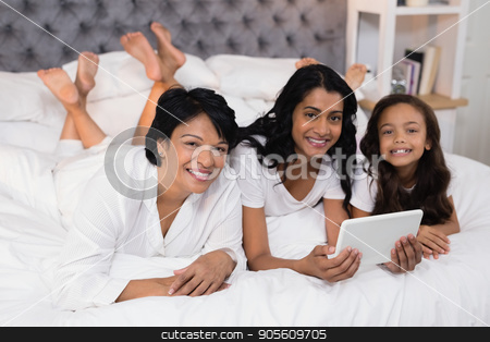 To use this stock image in your creative project, please select the size you need over to the right and click the "Add to Cart" button.
Your downloaded image will come with the Cutcaster watermark removed so don’t worry about the watermark you see on this page. Portrait of smiling multi-generation family using digital tablet while lying on bed stock photo, Portrait of smiling multi-generation family using digital tablet while lying on bed at home by Wavebreak Media