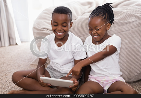 To use this stock image in your creative project, please select the size you need over to the right and click the "Add to Cart" button.
Your downloaded image will come with the Cutcaster watermark removed so don’t worry about the watermark you see on this page. Cheerful siblings using digital tablet while sitting on rug stock photo, Cheerful siblings using digital tablet while sitting on rug at home by Wavebreak Media