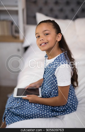 To use this stock image in your creative project, please select the size you need over to the right and click the "Add to Cart" button.
Your downloaded image will come with the Cutcaster watermark removed so don’t worry about the watermark you see on this page. Smiling girl holding digital tablet while sitting on bed at home stock photo, Portrait of smiling girl holding digital tablet while sitting on bed at home by Wavebreak Media