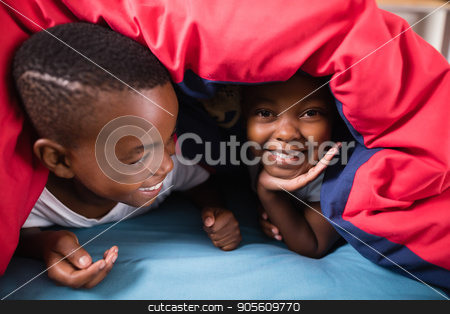 To use this stock image in your creative project, please select the size you need over to the right and click the "Add to Cart" button.
Your downloaded image will come with the Cutcaster watermark removed so don’t worry about the watermark you see on this page. Happy siblings playing under blanket at home stock photo, Close up of happy siblings playing under blanket on bed at home by Wavebreak Media