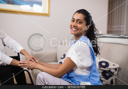 To use this stock image in your creative project, please select the size you need over to the right and click the "Add to Cart" button.
Your downloaded image will come with the Cutcaster watermark removed so don’t worry about the watermark you see on this page. Portrait of smiling doctor touching patient hands stock photo, Portrait of smiling young doctor touching patient hands at home by Wavebreak Media