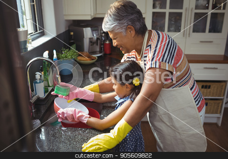 To use this stock image in your creative project, please select the size you need over to the right and click the "Add to Cart" button.
Your downloaded image will come with the Cutcaster watermark removed so don’t worry about the watermark you see on this page. Grandmother and granddaughter washing utensil in kitchen sink stock photo, Grandmother and granddaughter washing utensil in kitchen sink at home by Wavebreak Media