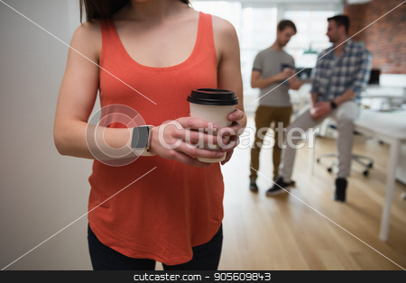 To use this stock image in your creative project, please select the size you need over to the right and click the "Add to Cart" button.
Your downloaded image will come with the Cutcaster watermark removed so don’t worry about the watermark you see on this page. Female executive holding coffee cup in office stock photo, Mid-section of female executive holding coffee cup in office by Wavebreak Media
