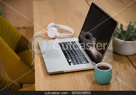 To use this stock image in your creative project, please select the size you need over to the right and click the "Add to Cart" button.
Your downloaded image will come with the Cutcaster watermark removed so don’t worry about the watermark you see on this page. Laptop with headphones and cup on table stock photo, Laptop with headphones and cup on table in office by Wavebreak Media