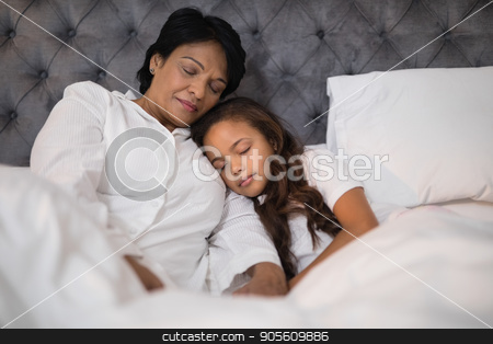 To use this stock image in your creative project, please select the size you need over to the right and click the "Add to Cart" button.
Your downloaded image will come with the Cutcaster watermark removed so don’t worry about the watermark you see on this page. Low angle view of grandmother and granddaughter napping on bed stock photo, Low angle view of grandmother and granddaughter napping on bed at home by Wavebreak Media