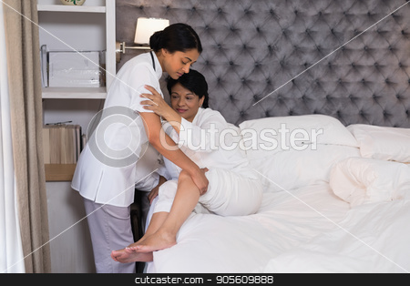 To use this stock image in your creative project, please select the size you need over to the right and click the "Add to Cart" button.
Your downloaded image will come with the Cutcaster watermark removed so don’t worry about the watermark you see on this page. Nurse helping patient on bed at home stock photo, Side view of nurse helping patient on bed at home by Wavebreak Media