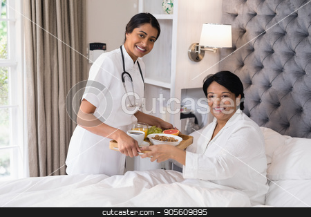 To use this stock image in your creative project, please select the size you need over to the right and click the "Add to Cart" button.
Your downloaded image will come with the Cutcaster watermark removed so don’t worry about the watermark you see on this page. Smiling nurse serving breakfast to patient resting on bed at home stock photo, Portrait of smiling nurse serving breakfast to patient resting on bed at home by Wavebreak Media