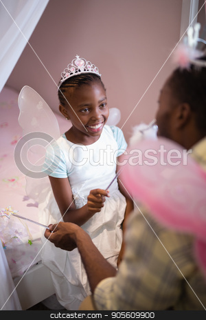 To use this stock image in your creative project, please select the size you need over to the right and click the "Add to Cart" button.
Your downloaded image will come with the Cutcaster watermark removed so don’t worry about the watermark you see on this page. Father and daughter wearing costume wings at home stock photo, High angle view of father and daughter wearing costume wings at home by Wavebreak Media