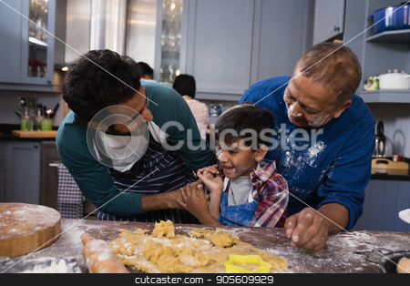 To use this stock image in your creative project, please select the size you need over to the right and click the "Add to Cart" button.
Your downloaded image will come with the Cutcaster watermark removed so don’t worry about the watermark you see on this page. Multi-generation family standing by dough in kitchen stock photo, Happy multi-generation family standing together by dough in kitchen at home by Wavebreak Media