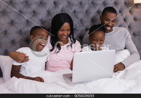 To use this stock image in your creative project, please select the size you need over to the right and click the "Add to Cart" button.
Your downloaded image will come with the Cutcaster watermark removed so don’t worry about the watermark you see on this page. Happy family using laptop while sitting together on bed stock photo, Happy family using laptop while sitting together on bed at home by Wavebreak Media