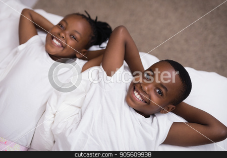 To use this stock image in your creative project, please select the size you need over to the right and click the "Add to Cart" button.
Your downloaded image will come with the Cutcaster watermark removed so don’t worry about the watermark you see on this page. Portrait of smiling siblings lying together on bed stock photo, High angle portrait of smiling siblings lying together on bed at home by Wavebreak Media