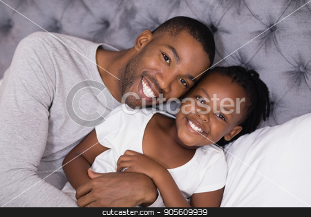 To use this stock image in your creative project, please select the size you need over to the right and click the "Add to Cart" button.
Your downloaded image will come with the Cutcaster watermark removed so don’t worry about the watermark you see on this page. Portrait of man with daughter lying on bed stock photo, High angle portrait of man with daughter lying on bed at home by Wavebreak Media