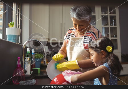 To use this stock image in your creative project, please select the size you need over to the right and click the "Add to Cart" button.
Your downloaded image will come with the Cutcaster watermark removed so don’t worry about the watermark you see on this page. Grandmother and granddaughter washing utensil in kitchen sink stock photo, Grandmother and granddaughter washing utensil in kitchen sink at home by Wavebreak Media