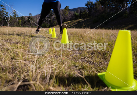 To use this stock image in your creative project, please select the size you need over to the right and click the "Add to Cart" button.
Your downloaded image will come with the Cutcaster watermark removed so don’t worry about the watermark you see on this page. Low-section of woman running through training cones stock photo, Low-section of woman running through training cones on a sunny day by Wavebreak Media