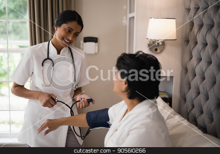 To use this stock image in your creative project, please select the size you need over to the right and click the "Add to Cart" button.
Your downloaded image will come with the Cutcaster watermark removed so don’t worry about the watermark you see on this page. Smiling nurse checking blood pressure of patient resting on bed stock photo, Smiling nurse checking blood pressure of patient resting on bed at home by Wavebreak Media