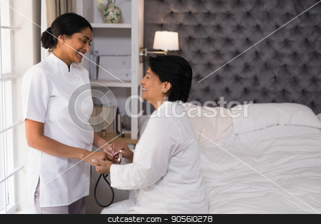 To use this stock image in your creative project, please select the size you need over to the right and click the "Add to Cart" button.
Your downloaded image will come with the Cutcaster watermark removed so don’t worry about the watermark you see on this page. Smiling nurse comforting mature woman on bed stock photo, Smiling nurse comforting mature woman on bed at home by Wavebreak Media