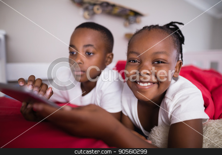 To use this stock image in your creative project, please select the size you need over to the right and click the "Add to Cart" button.
Your downloaded image will come with the Cutcaster watermark removed so don’t worry about the watermark you see on this page. Cheerful girl with brother using mobile phone on bed at home stock photo, Portrait of cheerful girl with brother using mobile phone on bed at home by Wavebreak Media