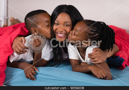 To use this stock image in your creative project, please select the size you need over to the right and click the "Add to Cart" button.
Your downloaded image will come with the Cutcaster watermark removed so don’t worry about the watermark you see on this page. Siblings kissing their mother while lying on bed stock photo, Siblings kissing their mother while lying on bed at home by Wavebreak Media