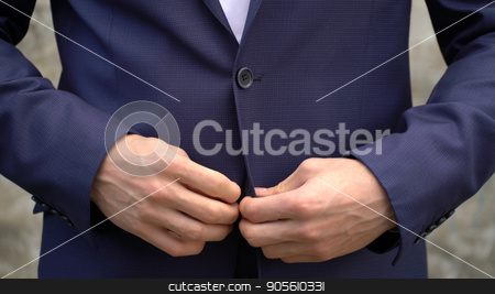 To use this stock image in your creative project, please select the size you need over to the right and click the "Add to Cart" button.
Your downloaded image will come with the Cutcaster watermark removed so don’t worry about the watermark you see on this page. The man fastens buttons on his jacket close up stock photo, The man fastens buttons on his jacket close up by petr zaika