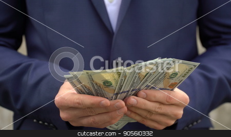 To use this stock image in your creative project, please select the size you need over to the right and click the "Add to Cart" button.
Your downloaded image will come with the Cutcaster watermark removed so don’t worry about the watermark you see on this page. Young businessman shows his money close-up stock photo, Young businessman shows his money close up by petr zaika