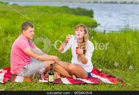 To use this stock image in your creative project, please select the size you need over to the right and click the "Add to Cart" button.
Your downloaded image will come with the Cutcaster watermark removed so don’t worry about the watermark you see on this page. Beautiful couple having a picnic in nature and blowing bubbles stock photo, Beautiful couple having a picnic in nature and blowing bubbles by Satura86