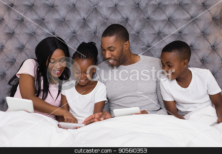 To use this stock image in your creative project, please select the size you need over to the right and click the "Add to Cart" button.
Your downloaded image will come with the Cutcaster watermark removed so don’t worry about the watermark you see on this page. Happy family using digital tablets together on bed stock photo, Happy family using digital tablets together while sitting on bed at home by Wavebreak Media
