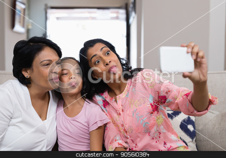 To use this stock image in your creative project, please select the size you need over to the right and click the "Add to Cart" button.
Your downloaded image will come with the Cutcaster watermark removed so don’t worry about the watermark you see on this page. Happy multi-generation family taking selfie while making faces stock photo, Happy multi-generation family taking selfie while making faces together at home by Wavebreak Media