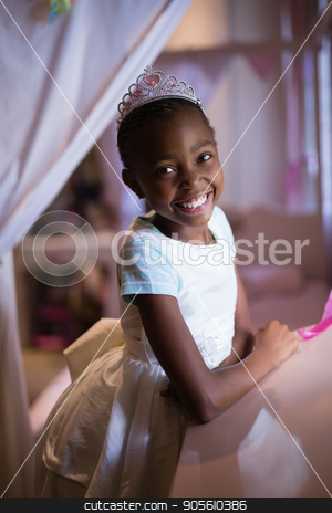 To use this stock image in your creative project, please select the size you need over to the right and click the "Add to Cart" button.
Your downloaded image will come with the Cutcaster watermark removed so don’t worry about the watermark you see on this page. Cheerful girl wearing crown while standing at home stock photo, Portrait of cheerful girl wearing crown while standing at home by Wavebreak Media