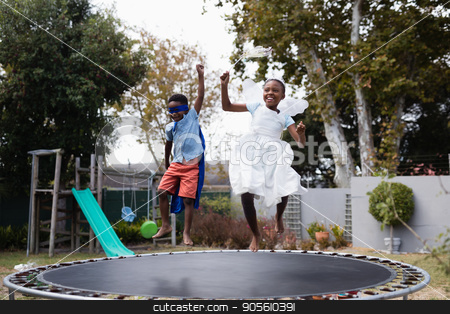 To use this stock image in your creative project, please select the size you need over to the right and click the "Add to Cart" button.
Your downloaded image will come with the Cutcaster watermark removed so don’t worry about the watermark you see on this page. Playful siblings in costumes enjoying on trampoline stock photo, Playful siblings in costumes enjoying on trampoline at lawn by Wavebreak Media