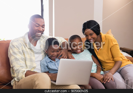 To use this stock image in your creative project, please select the size you need over to the right and click the "Add to Cart" button.
Your downloaded image will come with the Cutcaster watermark removed so don’t worry about the watermark you see on this page. Happy parents and children using laptop while sitting on sofa stock photo, Happy parents and children using laptop while sitting on sofa at home by Wavebreak Media