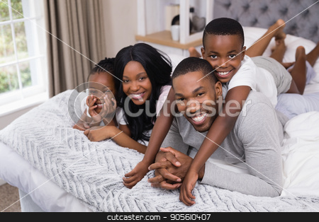 To use this stock image in your creative project, please select the size you need over to the right and click the "Add to Cart" button.
Your downloaded image will come with the Cutcaster watermark removed so don’t worry about the watermark you see on this page. Portrait of happy family lying together in bedroom stock photo, Portrait of happy family lying together in bedroom at home by Wavebreak Media