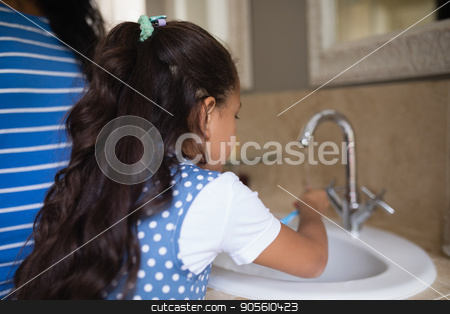 To use this stock image in your creative project, please select the size you need over to the right and click the "Add to Cart" button.
Your downloaded image will come with the Cutcaster watermark removed so don’t worry about the watermark you see on this page. Girl with mother brushing teeth at bathroom sink stock photo, Rear view of girl with mother brushing teeth at bathroom sink by Wavebreak Media