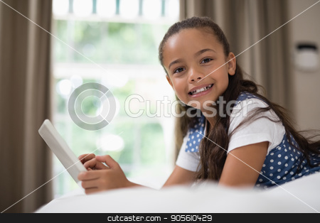 To use this stock image in your creative project, please select the size you need over to the right and click the "Add to Cart" button.
Your downloaded image will come with the Cutcaster watermark removed so don’t worry about the watermark you see on this page. Girl using digital tablet while lying on bed at home stock photo, Portrait of girl using digital tablet while lying on bed at home by Wavebreak Media