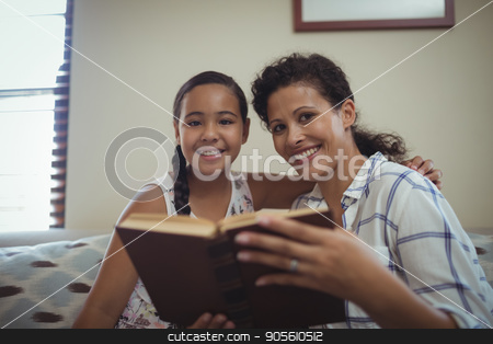 To use this stock image in your creative project, please select the size you need over to the right and click the "Add to Cart" button.
Your downloaded image will come with the Cutcaster watermark removed so don’t worry about the watermark you see on this page. Mother and daughter reading book in living room stock photo, Mother and daughter reading book in living room at home by Wavebreak Media