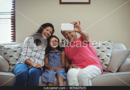 To use this stock image in your creative project, please select the size you need over to the right and click the "Add to Cart" button.
Your downloaded image will come with the Cutcaster watermark removed so don’t worry about the watermark you see on this page. Happy family taking a selfie on mobile phone in living room stock photo, Happy family taking a selfie on mobile phone in living room at home by Wavebreak Media