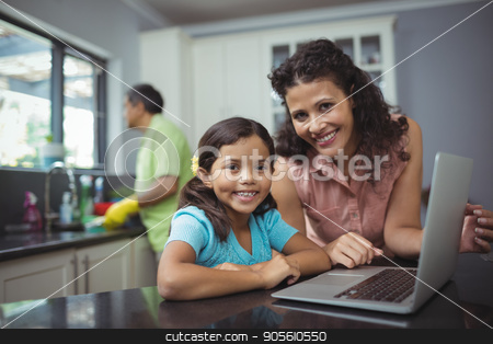 To use this stock image in your creative project, please select the size you need over to the right and click the "Add to Cart" button.
Your downloaded image will come with the Cutcaster watermark removed so don’t worry about the watermark you see on this page. Mother and daughter using laptop in kitchen stock photo, Portrait of mother and daughter using laptop in kitchen at home by Wavebreak Media