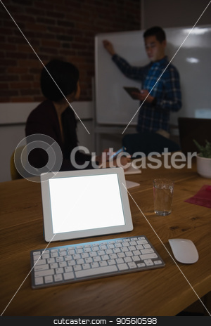To use this stock image in your creative project, please select the size you need over to the right and click the "Add to Cart" button.
Your downloaded image will come with the Cutcaster watermark removed so don’t worry about the watermark you see on this page. Digital tablet on table while colleague discussing in background stock photo, Digital tablet on table while colleague discussing in background at office by Wavebreak Media