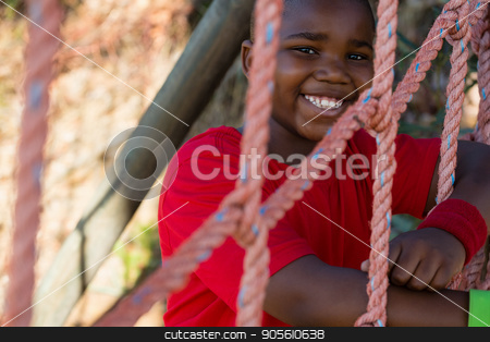 To use this stock image in your creative project, please select the size you need over to the right and click the "Add to Cart" button.
Your downloaded image will come with the Cutcaster watermark removed so don’t worry about the watermark you see on this page. Portrait of happy boy leaning on net during obstacle course stock photo, Portrait of happy boy leaning on net during obstacle course in the boot camp by Wavebreak Media