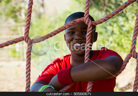 To use this stock image in your creative project, please select the size you need over to the right and click the "Add to Cart" button.
Your downloaded image will come with the Cutcaster watermark removed so don’t worry about the watermark you see on this page. Portrait of happy boy leaning on net during obstacle course stock photo, Portrait of happy boy leaning on net during obstacle course in the boot camp by Wavebreak Media
