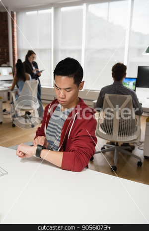 To use this stock image in your creative project, please select the size you need over to the right and click the "Add to Cart" button.
Your downloaded image will come with the Cutcaster watermark removed so don’t worry about the watermark you see on this page. Male executive adjusting a smart watch while colleague discussing in background stock photo, Male executive adjusting a smart watch while colleague discussing in background at office by Wavebreak Media