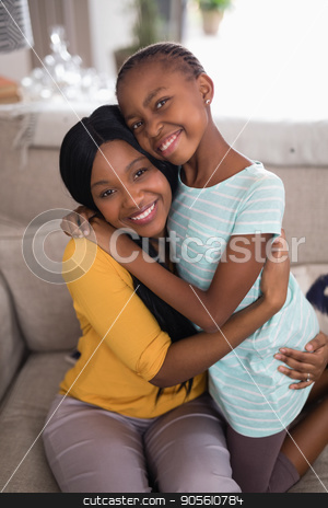To use this stock image in your creative project, please select the size you need over to the right and click the "Add to Cart" button.
Your downloaded image will come with the Cutcaster watermark removed so don’t worry about the watermark you see on this page. Smiling mother and daughter embracing on sofa at home stock photo, Portrait of smiling mother and daughter embracing on sofa at home by Wavebreak Media