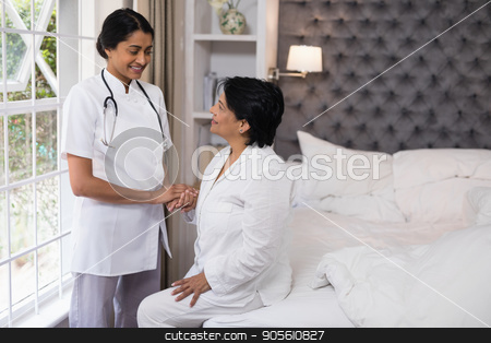 To use this stock image in your creative project, please select the size you need over to the right and click the "Add to Cart" button.
Your downloaded image will come with the Cutcaster watermark removed so don’t worry about the watermark you see on this page. Smiling nurse comforting female patient on bed stock photo, Smiling nurse comforting female patient on bed at home by Wavebreak Media