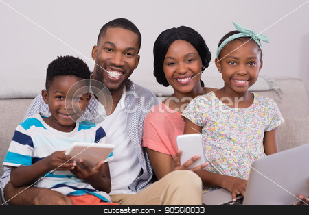 To use this stock image in your creative project, please select the size you need over to the right and click the "Add to Cart" button.
Your downloaded image will come with the Cutcaster watermark removed so don’t worry about the watermark you see on this page. Happy family with various technologies sitting on sofa at home stock photo, Portrait of happy family with various technologies sitting on sofa at home by Wavebreak Media