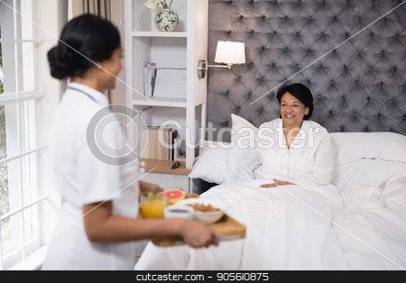 To use this stock image in your creative project, please select the size you need over to the right and click the "Add to Cart" button.
Your downloaded image will come with the Cutcaster watermark removed so don’t worry about the watermark you see on this page. Side view of nurse serving breakfast to patient resting on bed at home stock photo, Nurse serving breakfast to patient resting on bed at home by Wavebreak Media