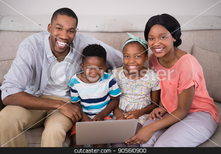 To use this stock image in your creative project, please select the size you need over to the right and click the "Add to Cart" button.
Your downloaded image will come with the Cutcaster watermark removed so don’t worry about the watermark you see on this page. Happy family holding laptop while sitting on sofa at home stock photo, Portrait of happy family holding laptop while sitting on sofa at home by Wavebreak Media