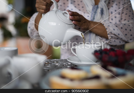 To use this stock image in your creative project, please select the size you need over to the right and click the "Add to Cart" button.
Your downloaded image will come with the Cutcaster watermark removed so don’t worry about the watermark you see on this page. Mid section of woman pouring tea in cup stock photo, Mid section of woman pouring tea in cup on table at home by Wavebreak Media
