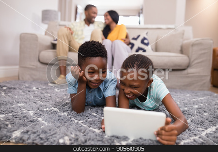 To use this stock image in your creative project, please select the size you need over to the right and click the "Add to Cart" button.
Your downloaded image will come with the Cutcaster watermark removed so don’t worry about the watermark you see on this page. Children using digital tablet while parents siting on sofa at home stock photo, Smiling children using digital tablet while parents siting on sofa at home by Wavebreak Media